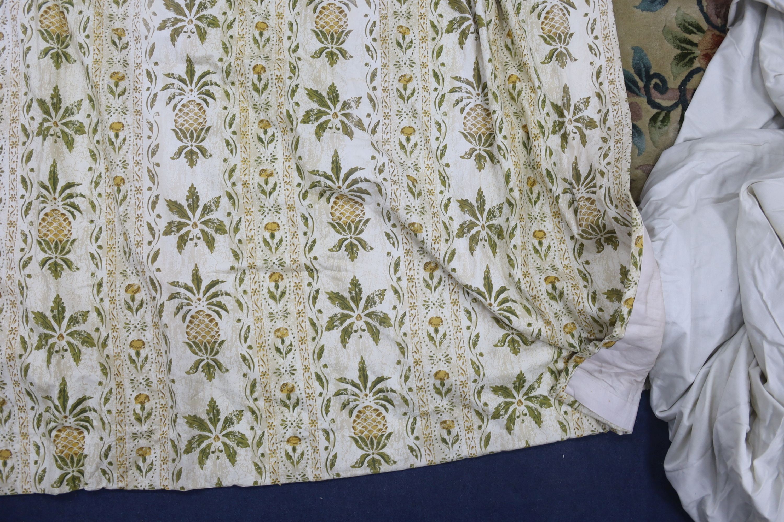 A pair of linen, 'Morris' style curtains and another pair of cotton curtains with a pineapple design